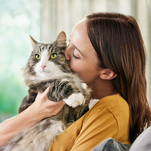woman cuddling her cat